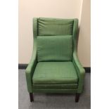 A mid 20th century Danish wingback armchair in green fabric