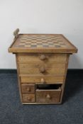 An oak and pine six drawer chest with chess board top