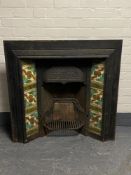 An antique cast iron tiled fire place