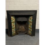 An antique cast iron tiled fire place