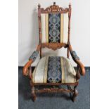 A carved scroll arm armchair in striped fabric