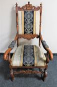 A carved scroll arm armchair in striped fabric