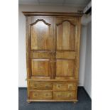 A contemporary hardwood double door wardrobe fitted four drawers