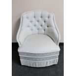 An Art Deco style bedroom chair in cream fabric