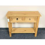 A Mexican pine side table fitted two drawers