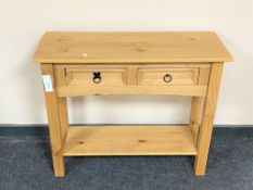 A Mexican pine side table fitted two drawers