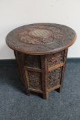 A carved folding Eastern hardwood table with bone inlay CONDITION REPORT: Small loss