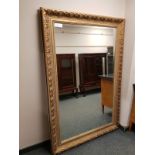 An ornate Victorian style gilt framed overmantel mirror,