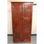 A stained pine double door wardrobe