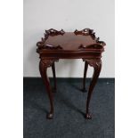 A reproduction mahogany occasional table on cabriole legs
