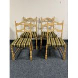 A set of four blonde oak dining chairs in striped fabric