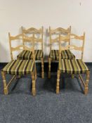 A set of four blonde oak dining chairs in striped fabric