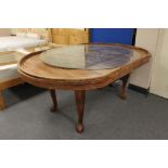 An Indian hardwood extending dining table with carved panel