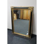 A Victorian style black and gilt framed mirror