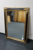 A Victorian style black and gilt framed mirror