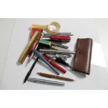 A box of assorted pens, pocket knives, magnifying glass,