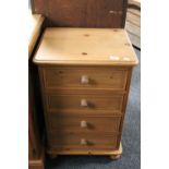A pine four drawer bedside chest