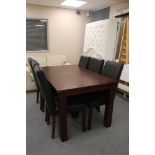 An oak effect dining table and six leather high backed chairs