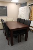An oak effect dining table and six leather high backed chairs
