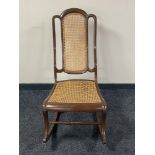 A painted 20th century bergere backed rocking chair