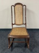 A painted 20th century bergere backed rocking chair