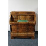 A continental inlaid mahogany barrel fronted bureau