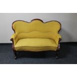 A continental mahogany two seater settee in mustard fabric