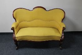 A continental mahogany two seater settee in mustard fabric