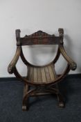 An early 20th century carved X-frame armchair