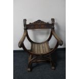 An early 20th century carved X-frame armchair