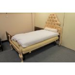 A 3'6" antique French bed frame in a cream classic fabric with horse hair mattress and base