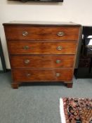 A George III mahogany four drawer chest on bracket feet,