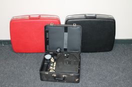 A cased Kodak Carousel projector and two luggage cases