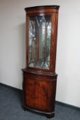 A reproduction corner display cabinet