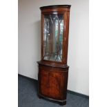 A reproduction corner display cabinet