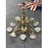An antique brass ten branch rise and fall chandelier