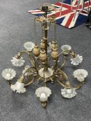 An antique brass ten branch rise and fall chandelier