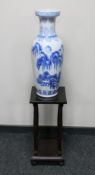 A late 20th century Chinese blue and white vase and a two tier plant stand on ball feet