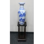 A late 20th century Chinese blue and white vase and a two tier plant stand on ball feet