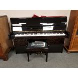 An Eterna by Yamaha ebonised upright overstrung piano model ER-C10, serial number C 20011,