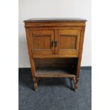 An oak double door cabinet CONDITION REPORT: 58cm wide by 27cm deep by 90cm high.
