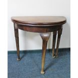 A Victorian D-shaped turnover top table on club feet