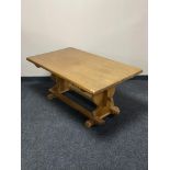 A blonde oak refectory coffee table