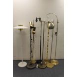 Eight assorted continental metal floor lamps