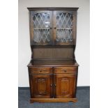 An oak dresser with leaded glass doors