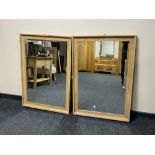 A pair of oak framed wall mirrors