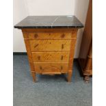 A continental satinwood four drawer chest with marble top, width 62 cm.