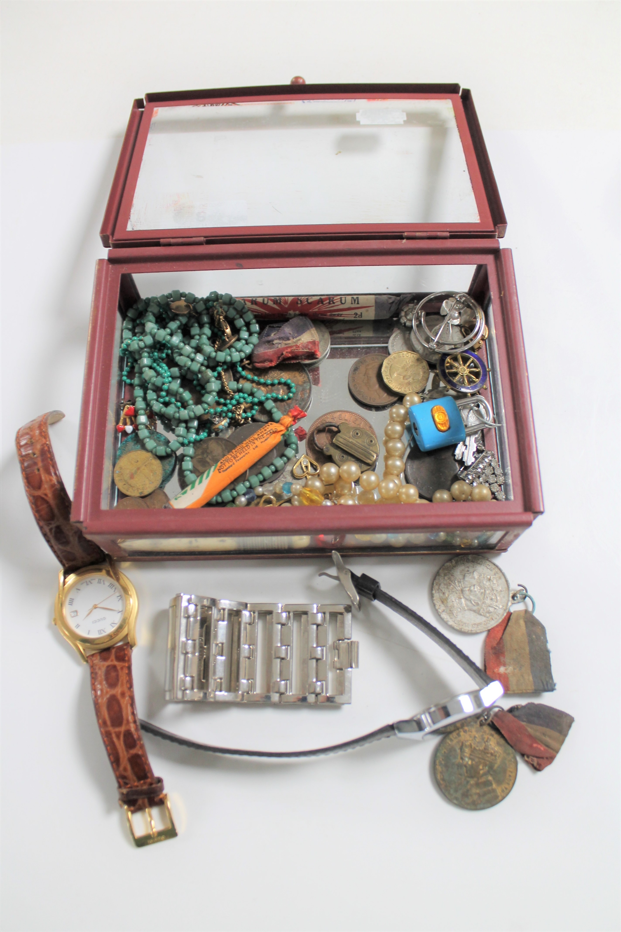 A box of medals on ribbons, costume jewellery, vintage firecrackers, coins,