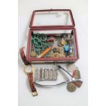 A box of medals on ribbons, costume jewellery, vintage firecrackers, coins,