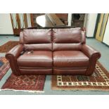 A good quality burgundy leather electric reclining two seater settee, width 195 cm.